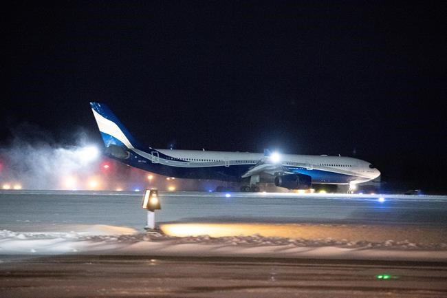 A plane carrying 176 Canadian citizens from the centre of the global novel coronavirus outbreak in Wuhan, China, lands at CFB Trenton, in Trenton, Ont., on Friday, Feb. 7, 2020. THE CANADIAN PRESS/Justin Tang
