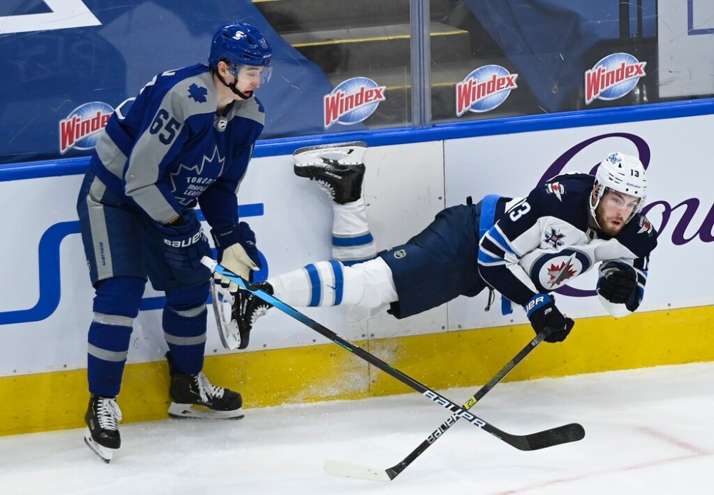 Winnipeg Jets' Pierre-Luc Dubois gets tripped up by Toronto Maple Leafs right wing Ilya Mikheyev during the second period. THE CANADIAN PRESS/Nathan Denette