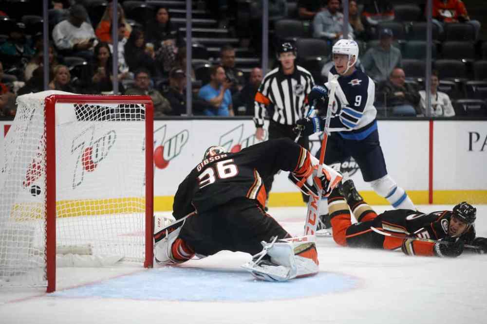 Winnipeg Jets' Andrew Copp scores over Anaheim Ducks’ Ryan Getzlaf on goaltender John Gibson during the third period. (TREVOR HAGAN / WINNIPEG FREE PRESS)