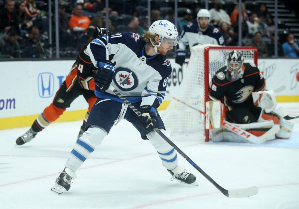 Winnipeg Jets' Kyle Connor (81) fires a backhand shot on Anaheim Ducks’ goaltender John Gibson (36) during first period hockey action in Anaheim, California, Tuesday, October 26, 2021. (TREVOR HAGAN / WINNIPEG FREE PRESS)