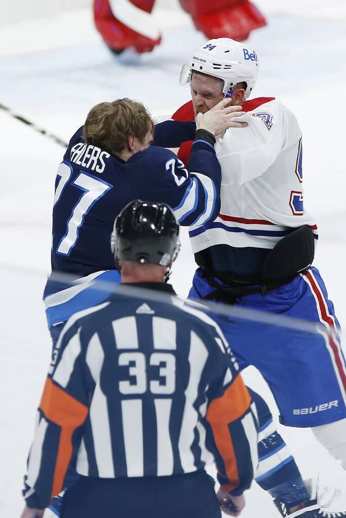 Winnipeg Jets' Nikolaj Ehlers and Montreal Canadiens' Corey Perry fight during the third period Thursday. THE CANADIAN PRESS/John Woods