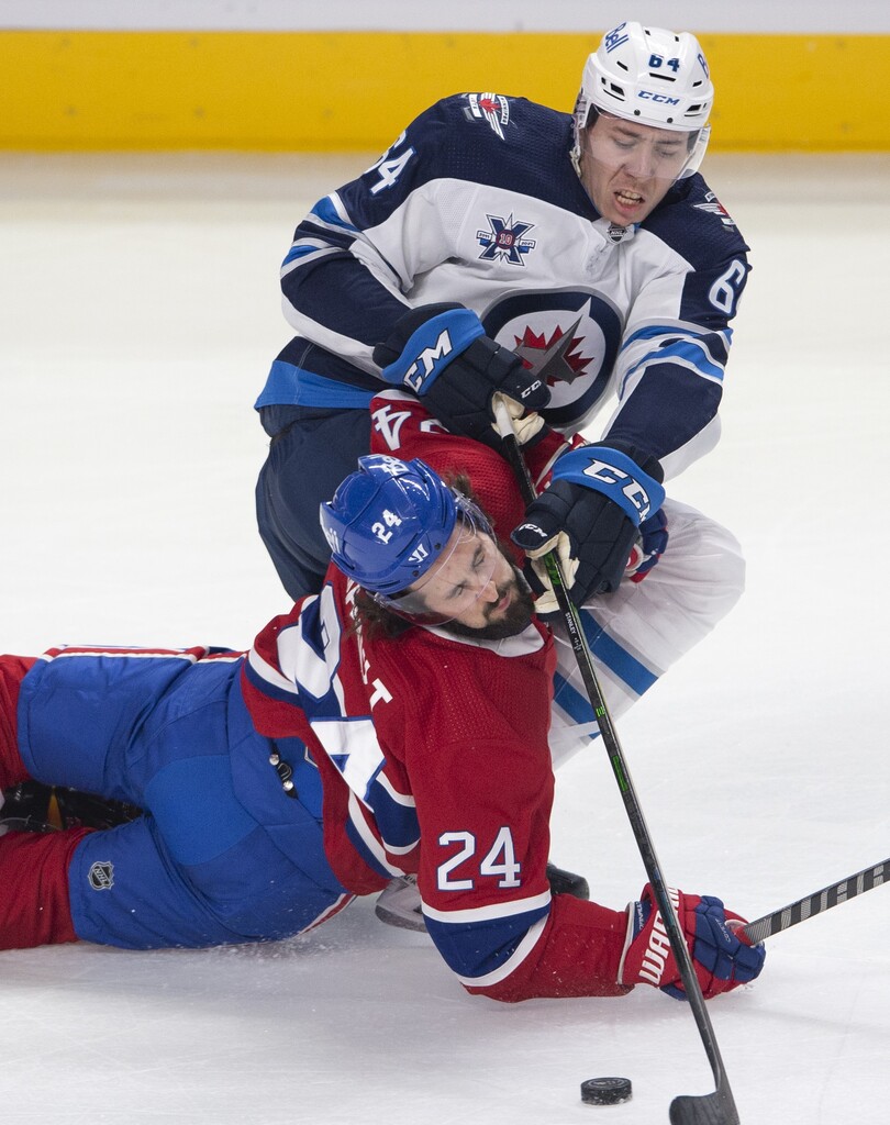 CP
Montreal Canadiens' Phillip Danault falls to the ice as he battles for a loose puck with Winnipeg Jets' Logan Stanley during the first period. THE CANADIAN PRESS/Ryan Remiorz
