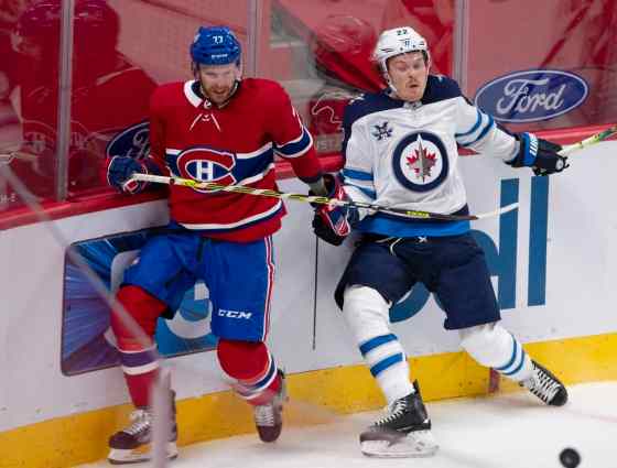 Montreal Canadiens' Brett Kulak and Winnipeg Jets' Mason Appleton go after a loose puck during second period NHL hockey action Thursday in Montreal. THE CANADIAN PRESS/Ryan Remiorz