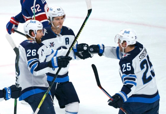 Winnipeg Jets' Paul Stastny, right, celebrates his goal against the Montreal Canadiens with teammates Blake Wheeler, left, and Mark Scheifele during the first period in Montreal on Thursday. THE CANADIAN PRESS/Paul Chiasson