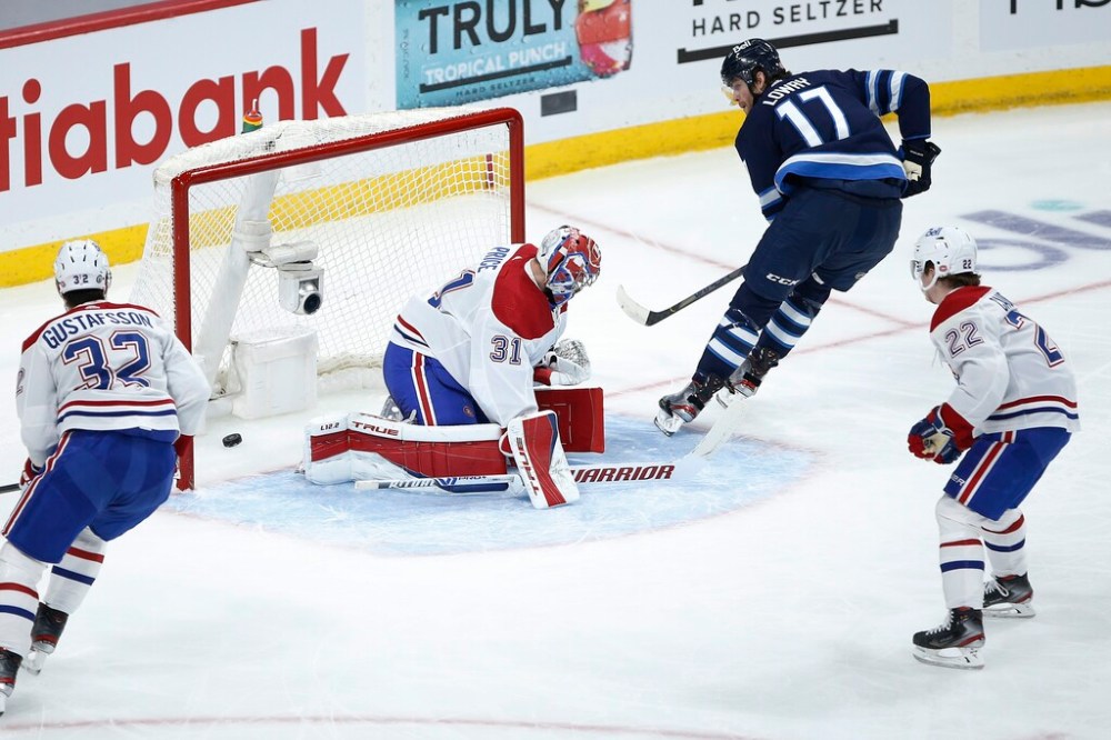 CP
Winnipeg Jets' Adam Lowry scores a short-handed goal through the 5-hole on Montreal Canadiens goaltender Carey Price during the first period. THE CANADIAN PRESS