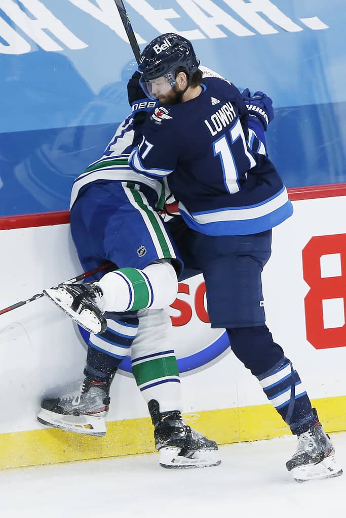 JOHN WOODS / WINNIPEG FREE PRESS
Winnipeg Jets’ Adam Lowry plays the body on Vancouver Canucks' Travis Hamonic during the second period.