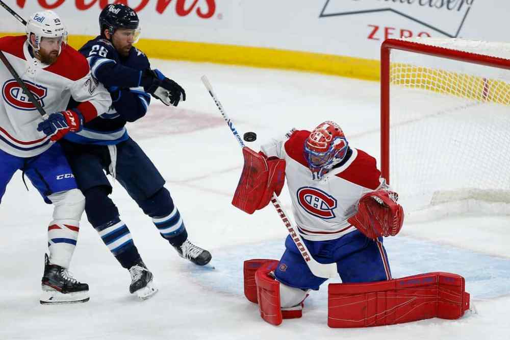 Winnipeg Jets' Blake Wheeler looks on as Montreal Canadiens goaltender Carey Price saves a shot and Jeff Petry defends during the second period. THE CANADIAN PRESS/John Woods