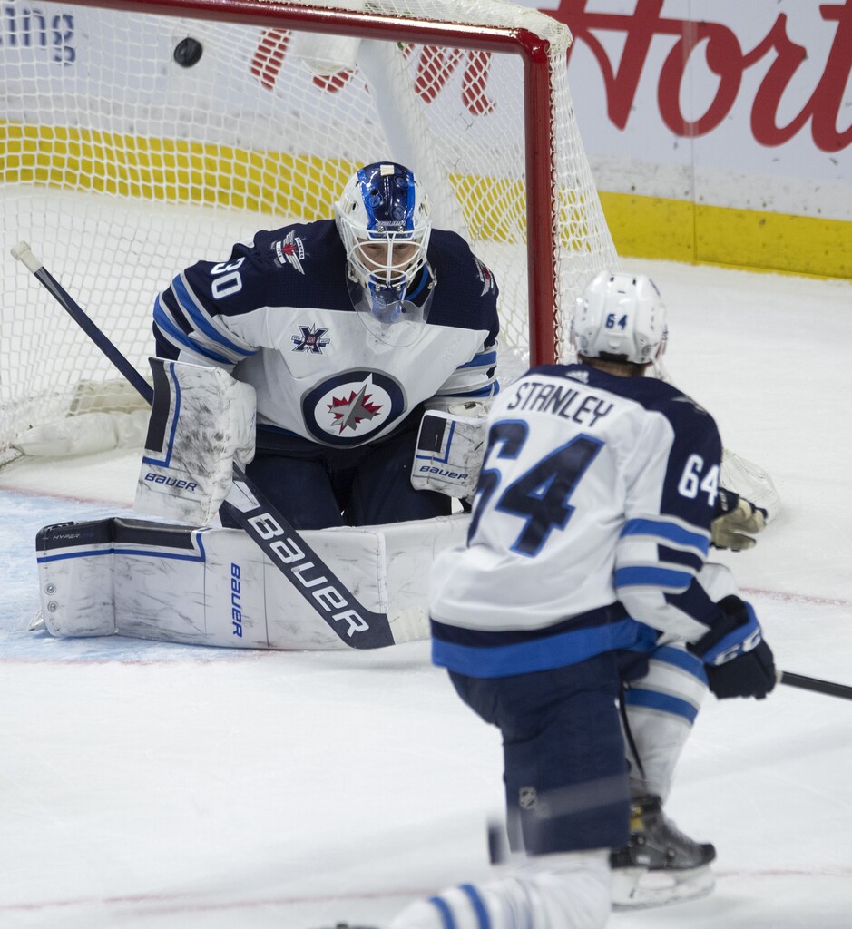 Winnipeg Jets defenceman Logan Stanley screens goaltender Laurent Brossoit on the Ottawa Senators' game-winning goal during the third period. THE CANADIAN PRESS/Adrian Wyld