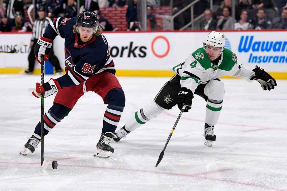 THE CANADIAN PRESS/Fred Greenslade
Winnipeg Jets' Kyle Connor protects the puck against Dallas Stars' Miro Heiskanen during the second period.