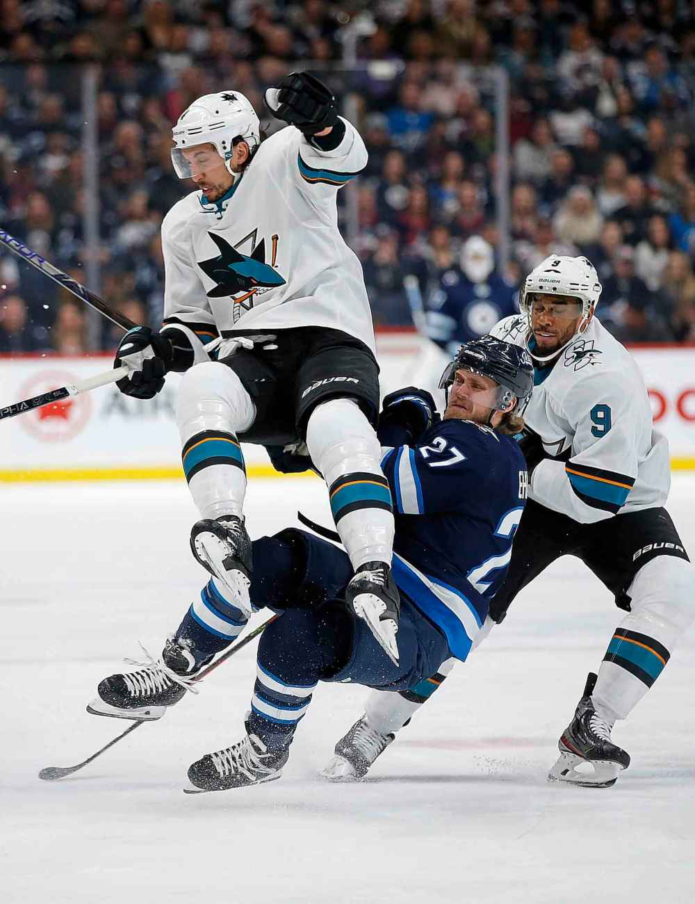 THE CANADIAN PRESS/John Woods
Winnipeg Jets' Nikolaj Ehlers and San Jose Sharks' Brenden Dillon collide as Evander Kane skates by during the second period.