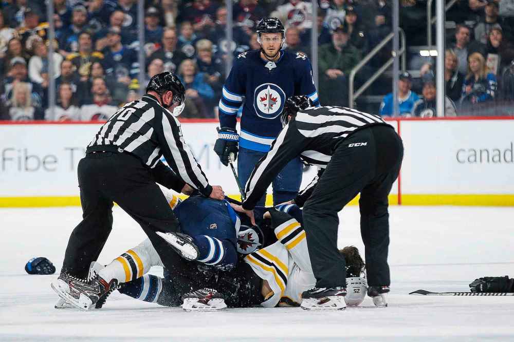 THE CANADIAN PRESS/John Woods
Winnipeg Jets' Anthony Bitetto looks on as Jets' Gabriel Bourque and Boston Bruins' Brandon Carlo fight during the second period.
