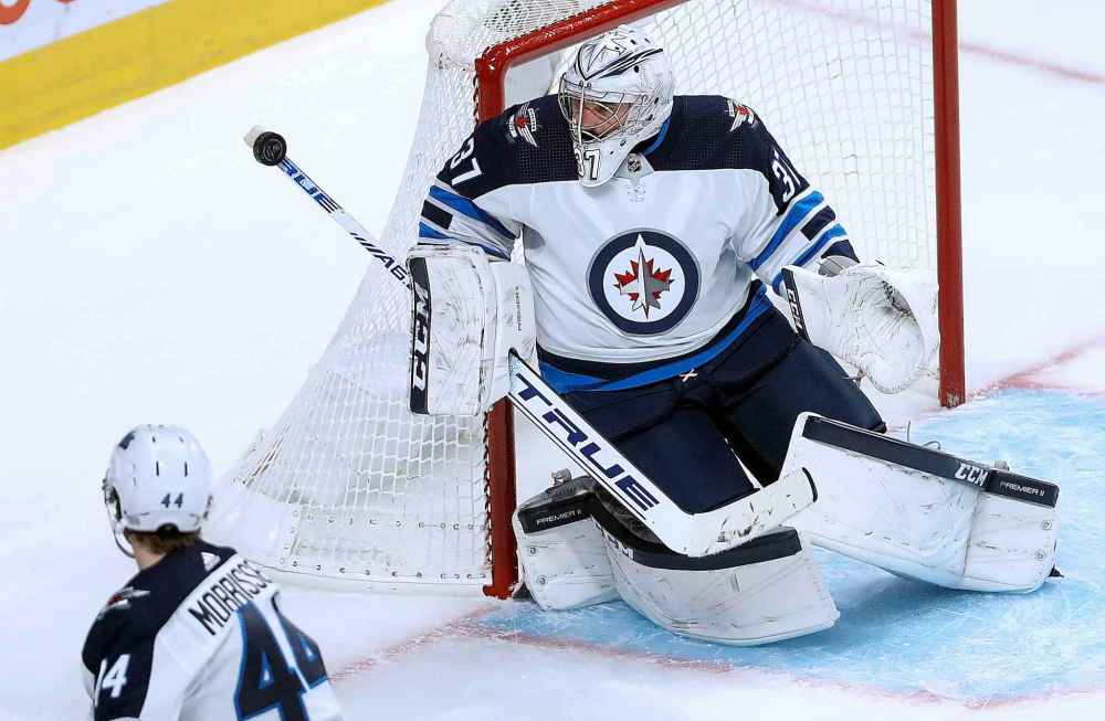 (TREVOR HAGAN / WINNIPEG FREE PRESS)
Winnipeg Jets' goaltender Connor Hellebuyck stops a shot with the butt end of his stick during the first period.