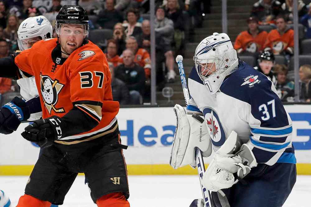 (AP Photo/Chris Carlson)
Winnipeg Jets goaltender Connor Hellebuyck blocks a shot as Anaheim Ducks left wing Nick Ritchie looks on during the second period Friday.