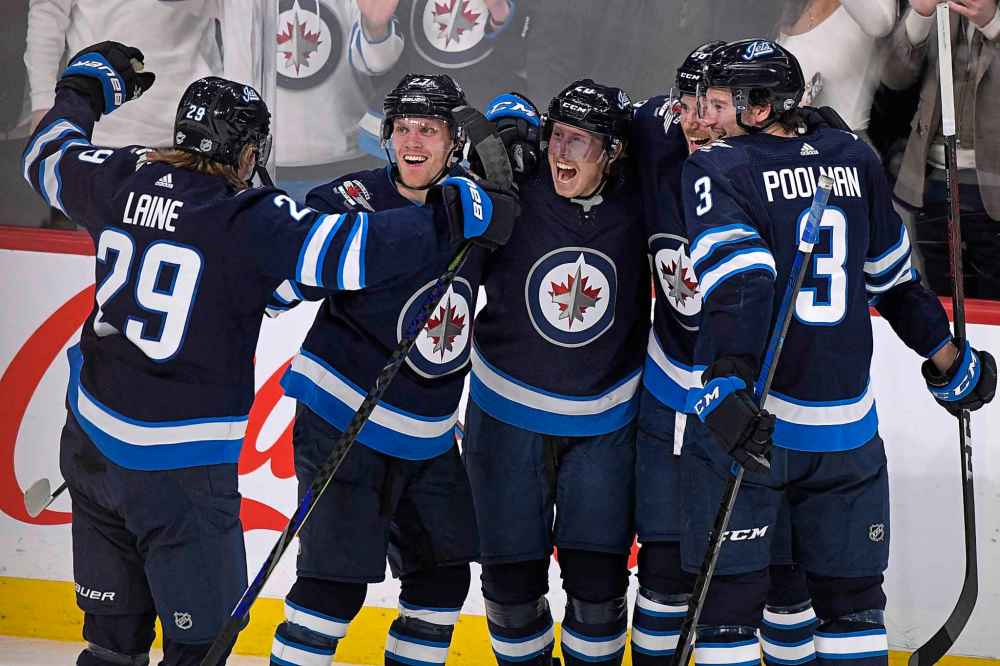 THE CANADIAN PRESS/Fred Greenslade
Cody Eakin, centre, celebrates his first goal as a Winnipeg Jet against the Arizona Coyotes with Patrik Laine, left to right, Nikolaj Ehlers, Nathan Beaulieu and Tucker Poolman during the third period in Winnipeg on Monday.