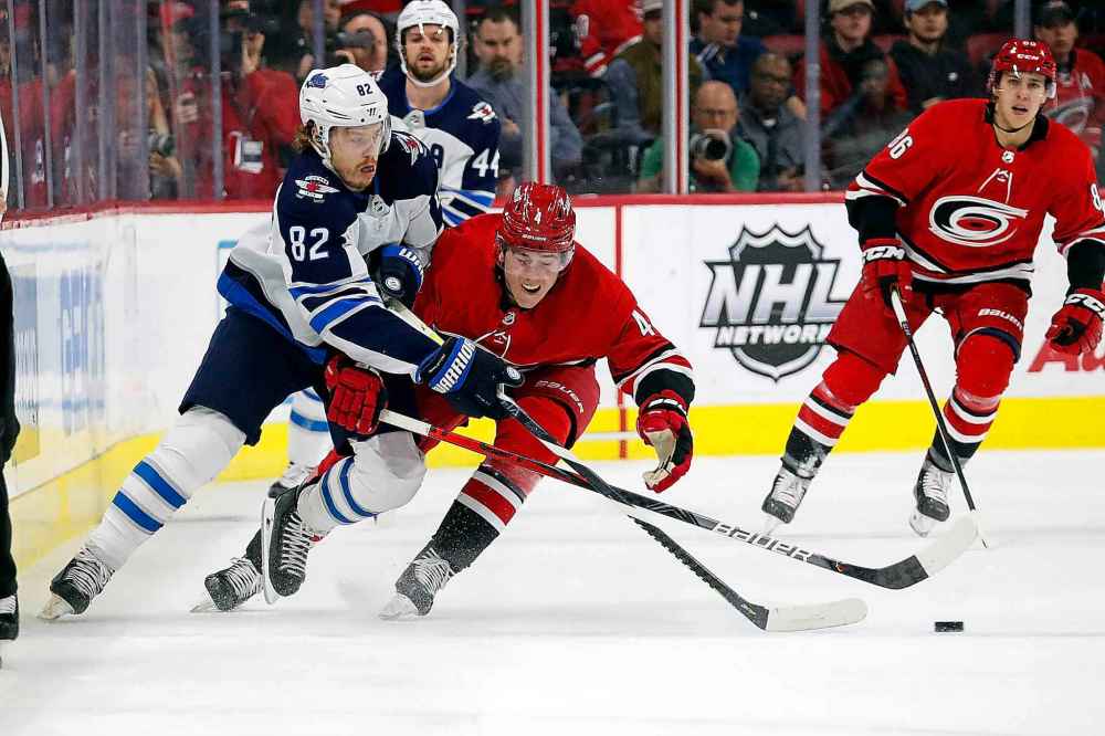 (AP Photo/Karl B DeBlaker)
Winnipeg Jets' Mason Appleton battles for the puck with Carolina Hurricanes' Haydn Fleury during the first period.