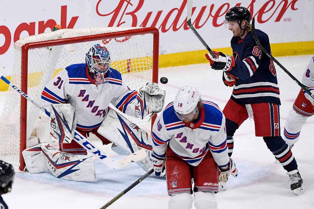 THE CANADIAN PRESS/Fred Greenslade
New York Rangers goaltender Igor Shesterkin makes a save on a Winnipeg Jets shot as Kyle Connor looks for the rebound during the first period.