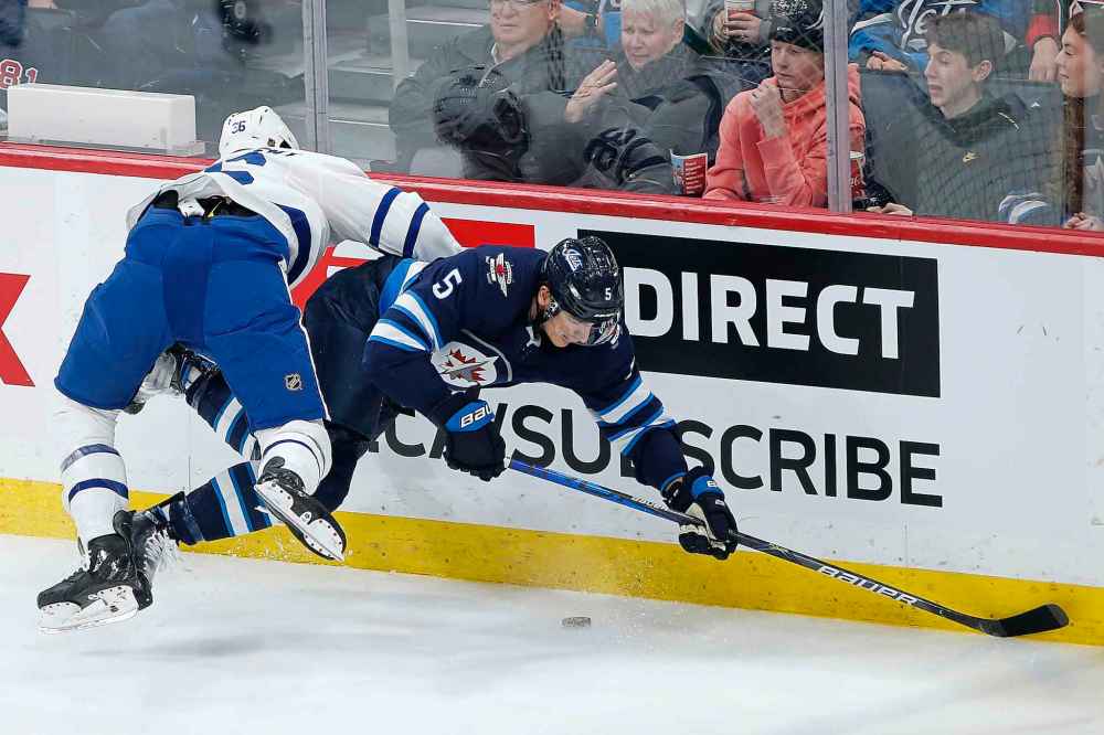 THE CANADIAN PRESS/John Woods
Winnipeg Jets' Luca Sbisa is checked by Toronto Maple Leafs' Mason Marchment during the first period Thursday.