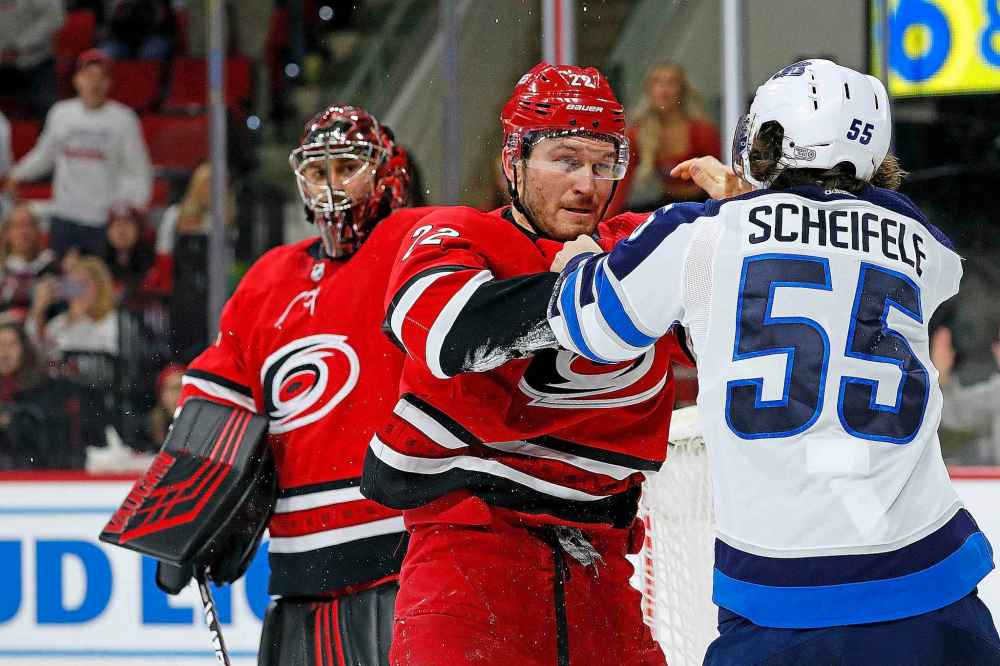 (AP Photo/Karl B DeBlaker)
Carolina Hurricanes' Brett Pesce exchanges blows with Winnipeg Jets' Mark Scheifele during the third period Tuesday.