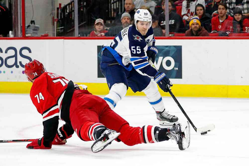 (AP Photo/Karl B DeBlaker)
Carolina Hurricanes' Jaccob Slavin leaves his skates to block Mark Scheifele's passing lane during the first period.