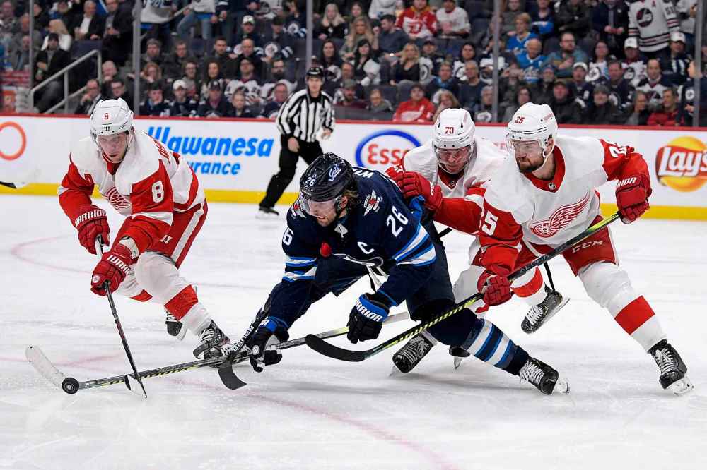 THE CANADIAN PRESS/Fred Greenslade
Winnipeg Jets' Blake Wheeler fights for possession of the puck against Detroit Red Wings' Justin Abdelkader, Christoffer Ehn and Mike Green during the second period.