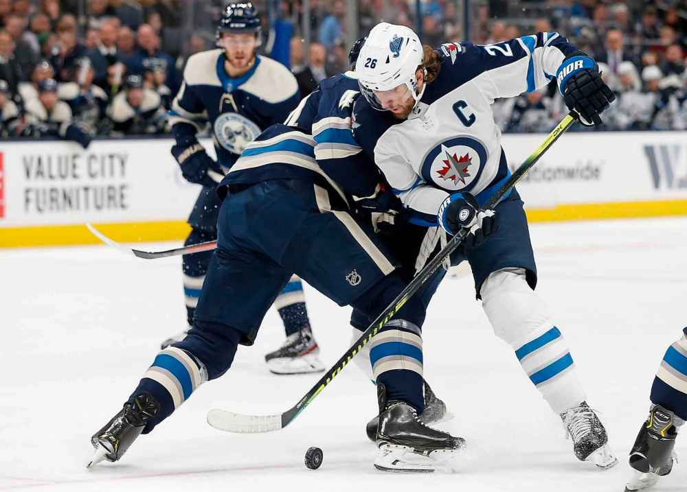 (AP Photo/Jay LaPrete)
Winnipeg Jets' Blake Wheeler, right, tries to carry the puck past Columbus Blue Jackets' Vladislav Gavrikov during the first period.