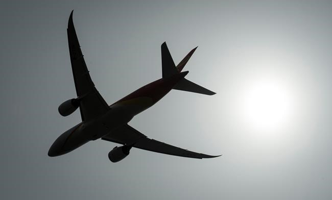 A plane is silhouetted as it takes off from Vancouver International Airport in Richmond, B.C., Monday, May 13, 2019. Airlines faced a rough landing at the House of Commons health committee Monday as MPs grilled them on the lack of refunds for customers whose flights were cancelled due to the COVID-19 pandemic. THE CANADIAN PRESS/Jonathan Hayward