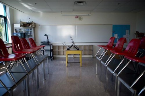 A empty classroom is pictured at McGee Secondary school in Vancouver, B.C. Friday, Sept. 5, 2014. British Columbia's education minister says students won't be back in classrooms on the originally planned date of Sept. 8. THE CANADIAN PRESS/Jonathan Hayward