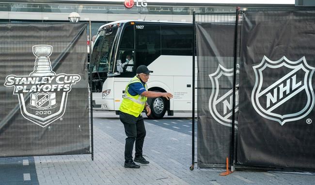 A security guard opens a gate for an empty player bus as it departs the Scotiabank Arena in Toronto on Thursday, Aug. 27, 2020. The professional sports schedule is expected to start getting busier on Friday after a string of postponements the past two days, but it won't be back to normal just yet. THE CANADIAN PRESS/Frank Gunn