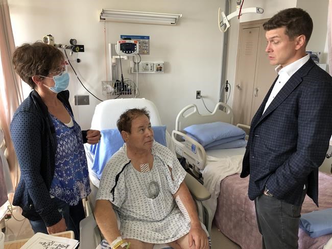 Dr. Corey Adams speaks with Shirley and Darrell Parker in this June 3, 2020 handout photo. A Saskatchewan man who suffered a heart attack after a hike in the Rocky Moutains last month says it was divine intervention that a cardiac surgeon happened to be on the same trail that day. Dr. Corey Adams helped resuscitate Darrell Parker, who was lying unconscious and blue at the side of a road near Canmore, Alta. THE CANADIAN PRESS/HO, Libin Cardiovascular Institute of Alberta *MANDATORY CREDIT*