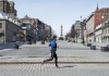 A runner passes an empty Place Jacques Cartier, Wednesday, March 25, 2020 in Montreal. Some Montreal restaurant owners are planning to take their pots and pans to the streets Wednesday morning, demanding answers on when they can reopen their restaurants. THE CANADIAN PRESS/Ryan Remiorz