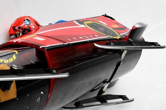 Italy's Tania Vicenzino and Lucrezia Tavella crash during the two-woman bobsled competition at the Bobsleigh and Skeleton World Championships in Altenberg, Germany, Friday, Feb. 21, 2020. (AP Photo/Jens Meyer)
