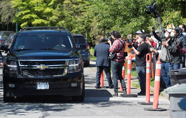 Members of the media photograph the vehicle carrying Meng Wanzhou, chief financial officer of Huawei, to B.C. Supreme Court in Vancouver, Wednesday, May 27, 2020. Canada joined with its major allies Thursday in condemning China for imposing a new national security law on Hong Kong, one day after a contentious B.C. court ruling in the Meng Wanzhou affair. THE CANADIAN PRESS/Jonathan Hayward