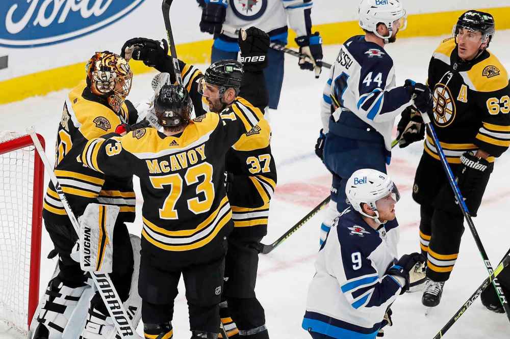 CP
Boston Bruins' Tuukka Rask (40) celebrates with Charlie McAvoy (73) and Patrice Bergeron (37) after defeating the Winnipeg Jets. (Michael Dwyer / The Associated Press)