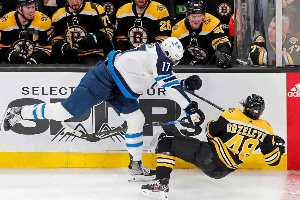 CP
Winnipeg Jets' Adam Lowry checks Boston Bruins' Matt Grzelcyk during the second period. (Michael Dwyer / The Associated Press)