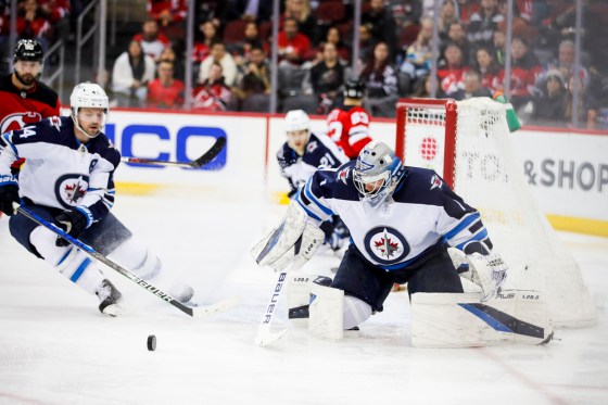 CPWinnipeg Jets goaltender Eric Comrie keeps an eye on the puck after a save during the third period of the Jets 2-1 victory against New Jersey Devils Thursday in Newark. (AP Photo/Eduardo Munoz Alvarez)