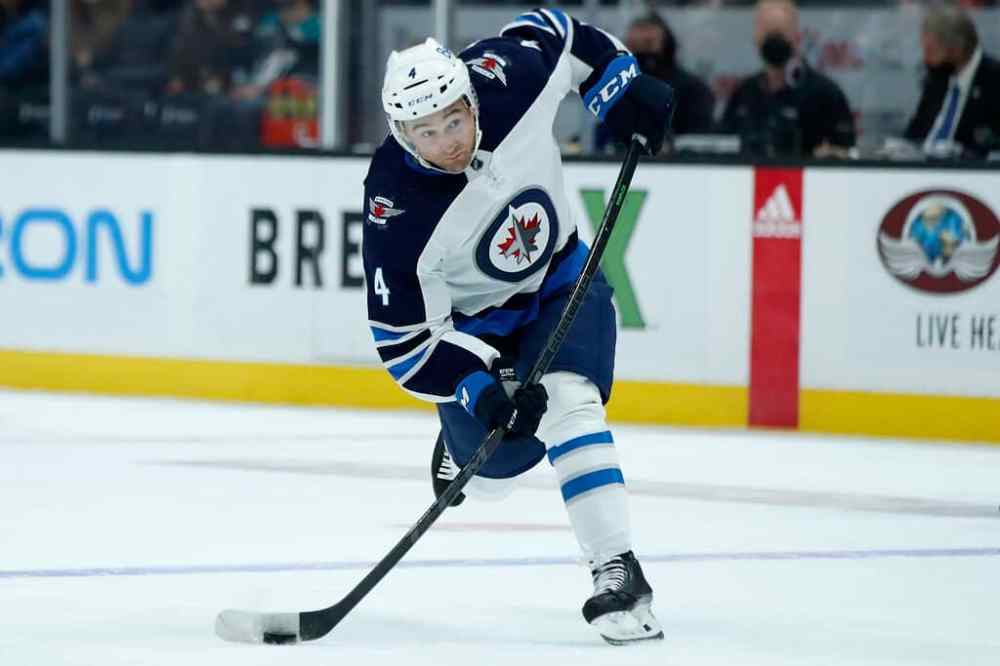 CP
Winnipeg Jets defenceman Neal Pionk leans into a shot against the Anaheim Ducks during the first period. (AP Photo/Alex Gallardo)