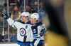 Winnipeg Jets center Mark Scheifele, left, and center Paul Stastny (25) celebrate after Stastny scored a goal against the Vegas Golden Knights during the third period Sunday, Jan. 2, 2022 in Las Vegas. (Ellen Schmidt / The Associated Press)