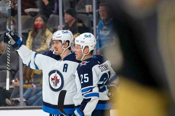 Winnipeg Jets center Mark Scheifele, left, and center Paul Stastny (25) celebrate after Stastny scored a goal against the Vegas Golden Knights during the third period Sunday, Jan. 2, 2022 in Las Vegas. (Ellen Schmidt / The Associated Press)