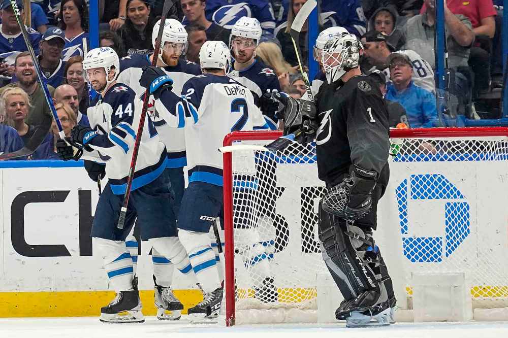 CP
Winnipeg Jets defenseman Josh Morrissey celebrates with teammates after scoring past Tampa Bay Lightning goaltender Brian Elliott during the second period. (Chris O'Meara / The Associated Press)