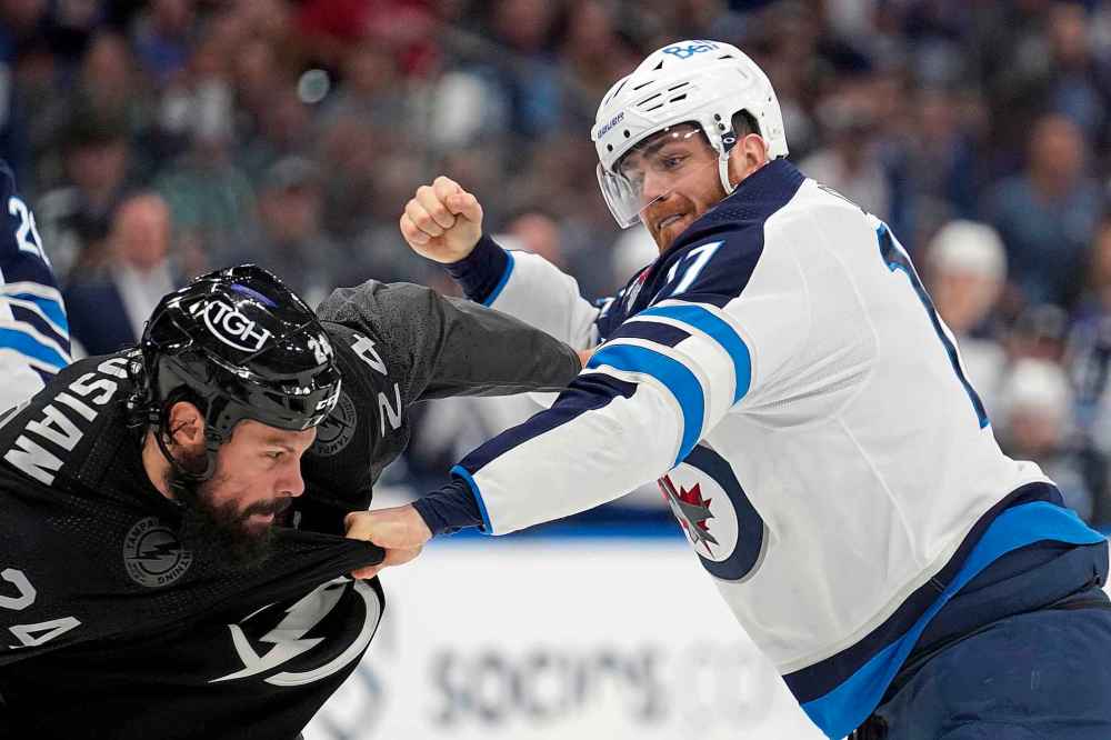 CP
Winnipeg Jets center Adam Lowry and Tampa Bay Lightning defenseman Zach Bogosian fight during the first period. (Chris O'Meara / The Associated Press)
