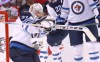 Winnipeg Jets goaltender Connor Hellebuyck (37) makes a glove-save during the first period of an NHL hockey game against the Florida Panthers, Friday, April 15, 2022, in Sunrise, Fla. (AP Photo/Reinhold Matay)