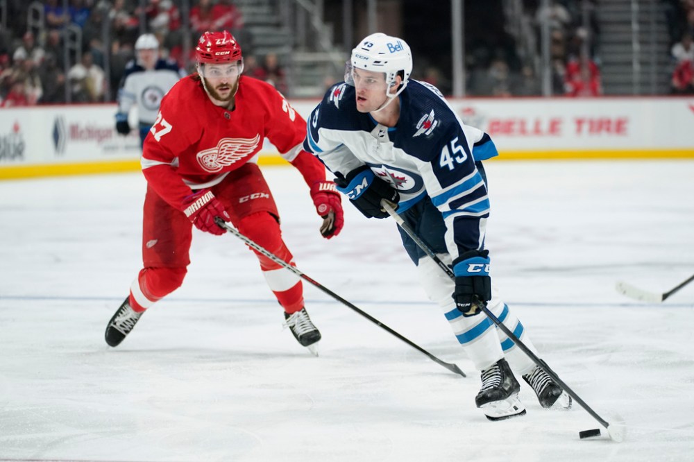 (AP Photo/Paul Sancya)
Winnipeg Jets defenceman Declan Chisholm loads up to shoot as Detroit Red Wings centre Michael Rasmussen watches in the third period.
