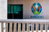 The Euro 2020 logo displayed next to the entrance of the UEFA Headquarters, in Nyon, Switzerland, Tuesday, March 17, 2020. The UEFA meet on 17 March 2020 to discuss the effects of the coronavirus pandemic on the UEFA EURO 2020 and the European Cup competitions. For most people, the new coronavirus causes only mild or moderate symptoms, such as fever and cough. For some, especially older adults and people with existing health problems, it can cause more severe illness, including pneumonia. (Jean-Christophe Bott/Keystone via AP)