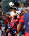 United States forward Gyasi Zardes (9) and Canada defender Steven Vitoria (5) go up for the ball during the first half of a CONCACAF Gold Cup soccer match in Kansas City, Kan., Sunday, July 18, 2021. (AP Photo/Colin E. Braley)