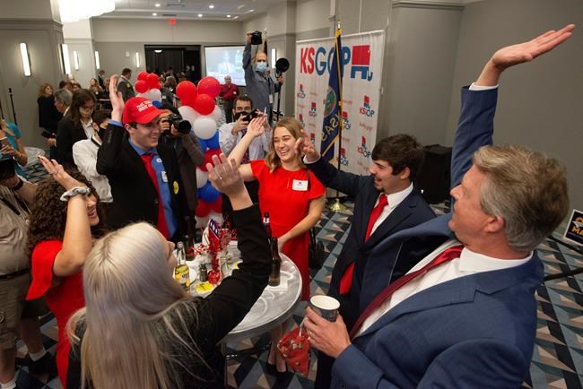 Congressman Roger Marshall goes hands in with college students prior to results at a GOP watch party at the Cyrus Hotel Tuesday evening, Nov. 3, 2020 in Topeka, Kan. Marshall is running against Barbara Bollier for the Kansas seat in the U.S. Senate. (Evert Nelson/The Topeka Capital-Journal via AP)