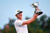Seamus Power holds up the trophy following his victory in the Barbasol Championship golf tournament at Keene Trace in Nicholasville, Ky., Sunday, July 18, 2021. Power's victory over J.T. Poston came after six playoff holes. (AP Photo/Timothy D. Easley)