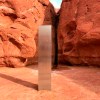 This Nov. 18, 2020 photo provided by the Utah Department of Public Safety shows a metal monolith installed in the ground in a remote area of red rock in Utah. The smooth, tall structure was found during a helicopter survey of bighorn sheep in southeastern Utah, officials said Monday. State workers from the Utah Department of Public Safety and Division of Wildlife Resources spotted the gleaming object from the air and landed nearby to check it out. The exact location is so remote that officials are not revealing it publicly, worried that people might get lost or stranded trying to find it and need to be rescued. (Utah Department of Public Safety via AP)