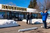FILE - In this March 11, 2019, file photo Debby Saltzman, of Bend, Ore., poses for a photo, in front of the last Blockbuster store with her twin brother, Michael, visiting from Melbourne, Australia, in Bend, Ore. Taking the photo is Saltzman's husband, Jeremy Saltzman. The new Netflix movie called The Last Blockbuster that began airing March 15, 2021 is generating interest in the store, which became the last Blockbuster location on Earth when a location in Perth, Australia shut its doors in 2019. (AP Photo/Gillian Flaccus)