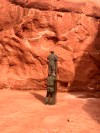 This Nov. 18, 2020 photo provided by the Utah Department of Public Safety shows Utah state workers checking out a metal monolith that was found installed in the ground in a remote area of red rock in Utah. The smooth, tall structure was found during a helicopter survey of bighorn sheep in southeastern Utah, officials said Monday. State workers from the Utah Department of Public Safety and Division of Wildlife Resources spotted the gleaming object from the air and landed nearby to check it out. The exact location is so remote that officials are not revealing it publicly, worried that people might get lost or stranded trying to find it and need to be rescued. (Utah Department of Public Safety via AP)