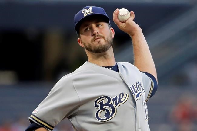 FILE - In this Aug. 7, 2019, file photo, Milwaukee Brewers starting pitcher Drew Pomeranz delivers during the first inning of the team's baseball game against the Pittsburgh Pirates in Pittsburgh. Pomeranz moved to the San Diego Padres for the 2020 season. (AP Photo/Gene J. Puskar, File)